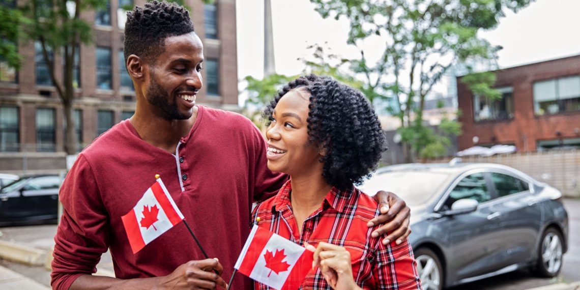 couple holding a flag of Canada